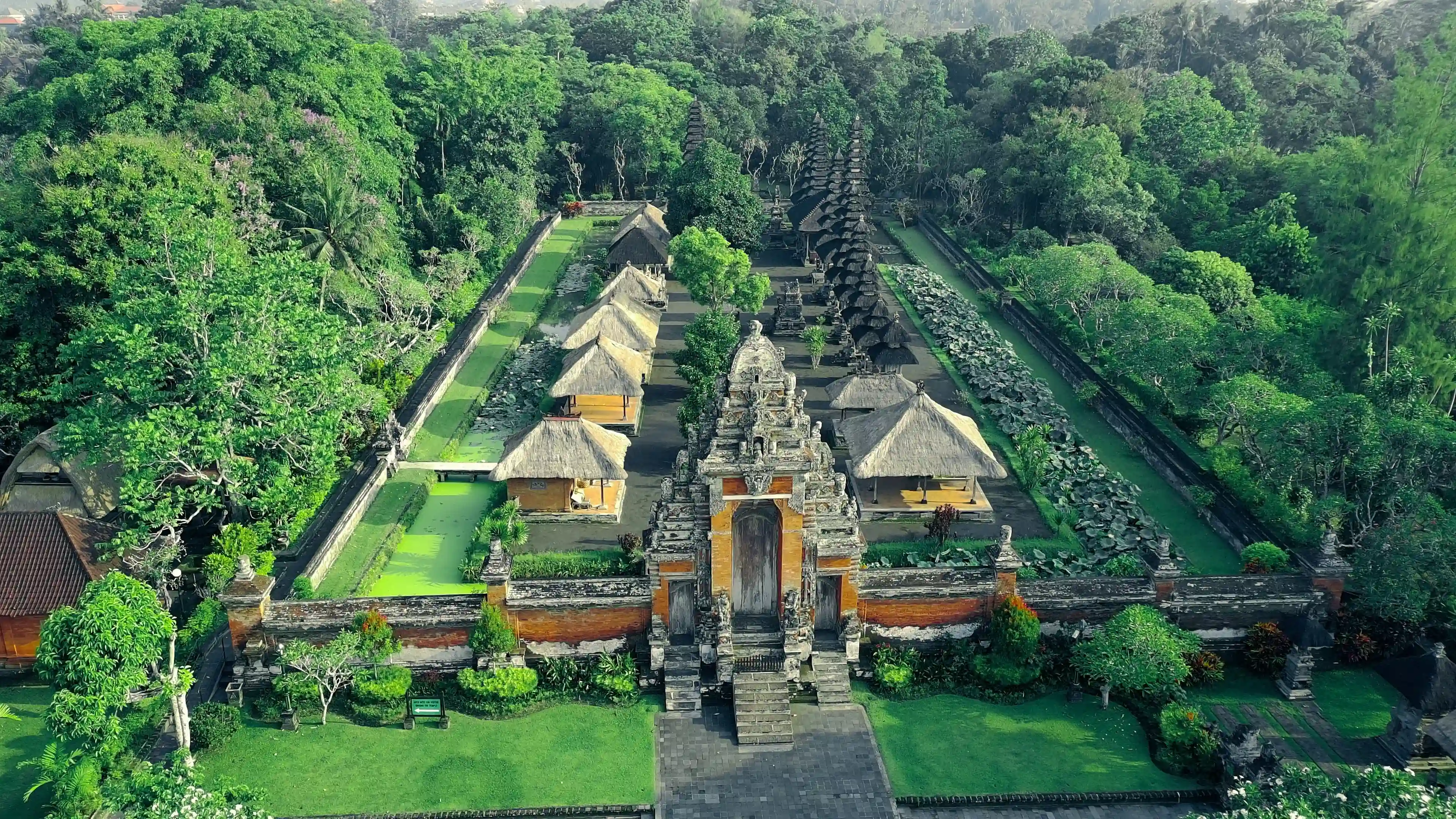 Wide-angle view of Taman Ayun Temple with its traditional multi-tiered roofs and surrounding moat
